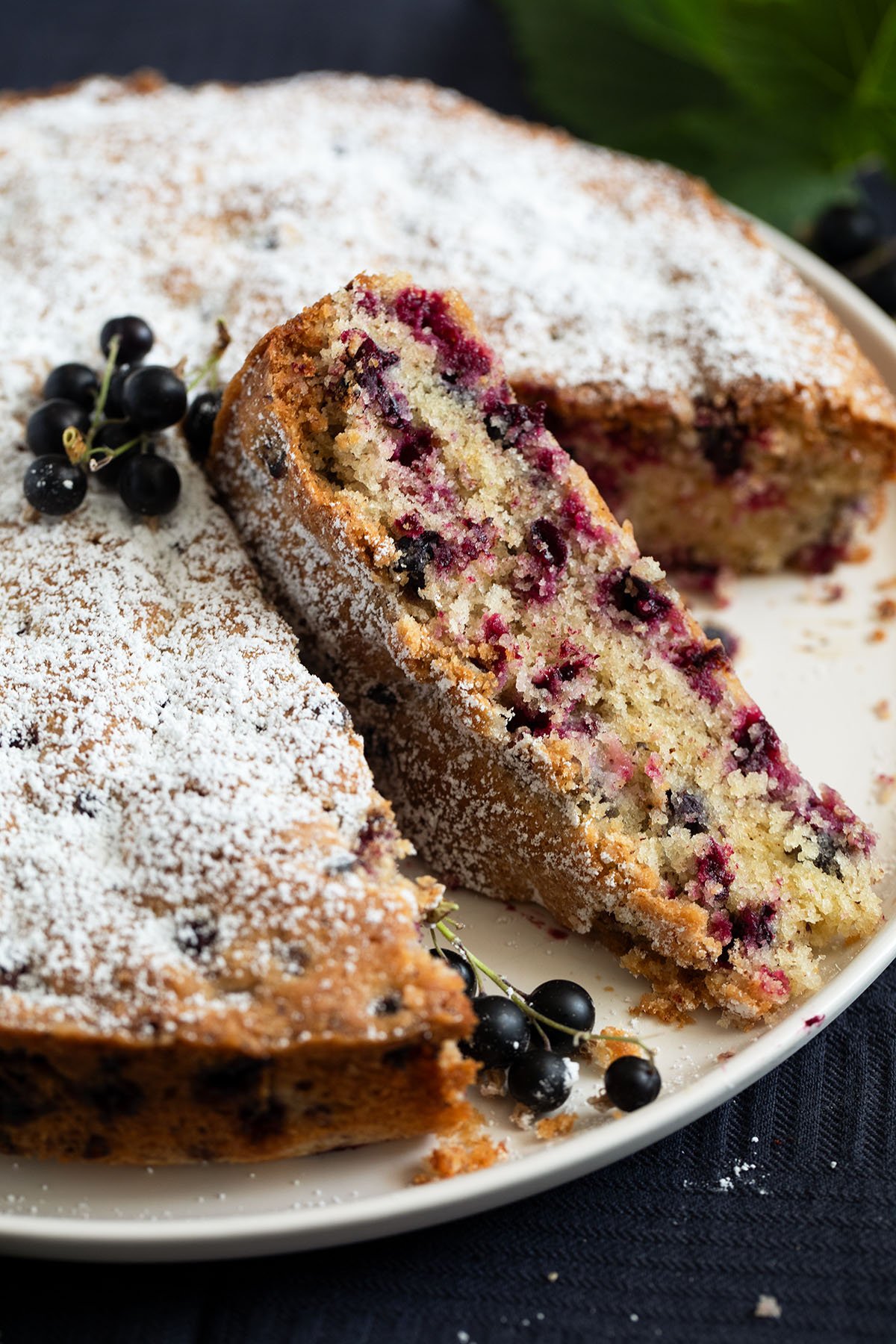 sliced blackcurrant cake on a cake platter.