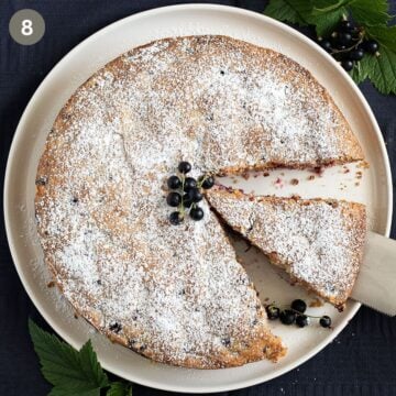 lifting a slice of blackcurrant cake with a cake lifter.