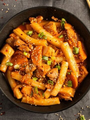 chicken rice cake stir fry in a bowl.