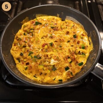 set zucchini and green onion omelet in a frying pan.