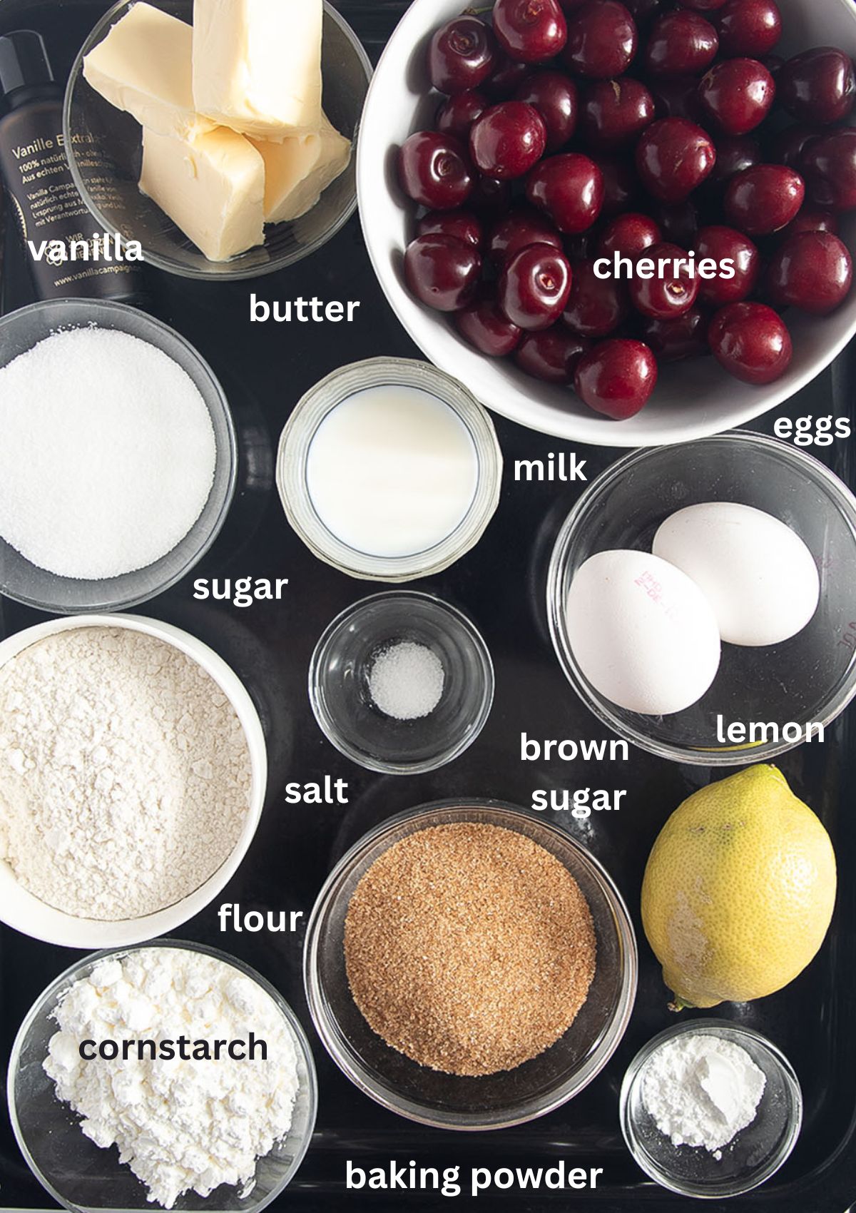 labeled ingredients for making cherry cake with crumbles.