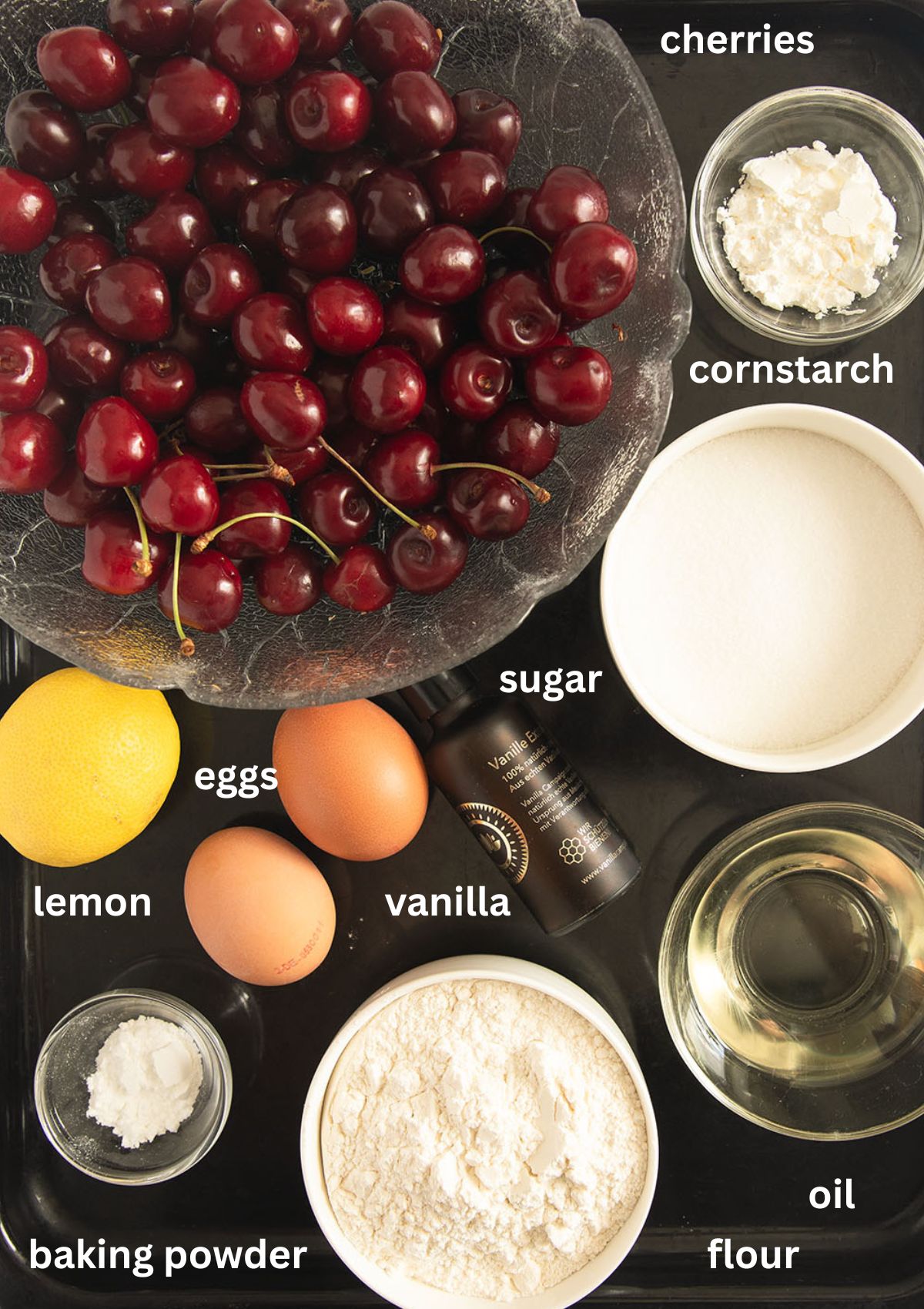 labeled ingredients for making cherry cake.