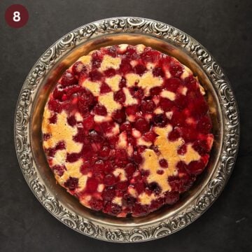 baked upside down cake with cherries on a platter.