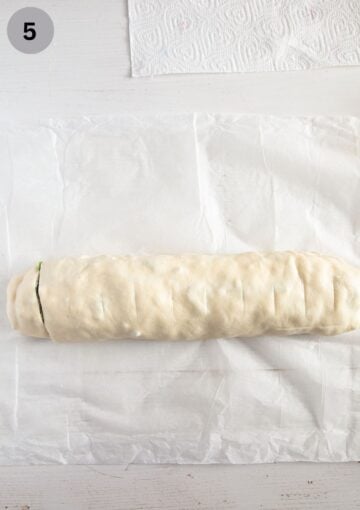 rolled piece of dough before cutting the rolls out of it.