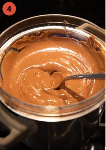 melting milk chocolate in a large bowl and stirring it with a spoon.