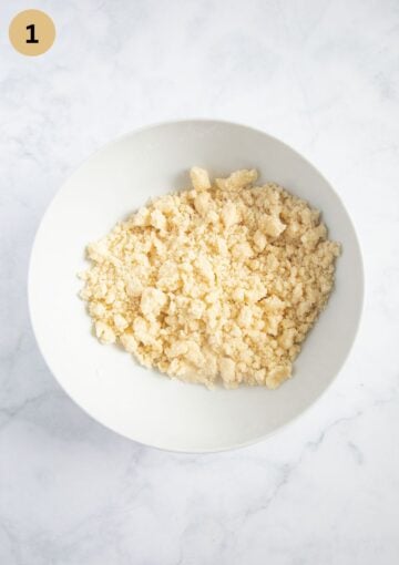 Cold butter cubes rubbed into flour, sugar, and salt to make the crumble topping.