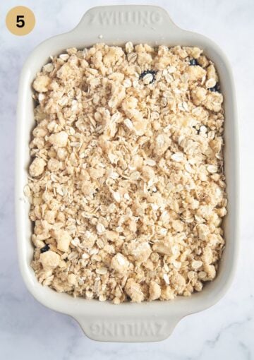 apple and blueberry crumble in baking dish before baking.