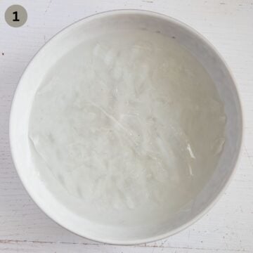 soaking gelatin leaves in cold water in a bowl.