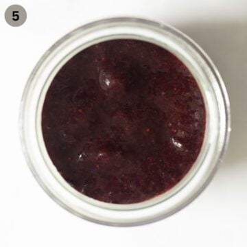 topping panna cotta with fresh blueberry sauce.