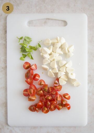 small chopped baby tomatoes, mini mozzarella balls and basil leaves.