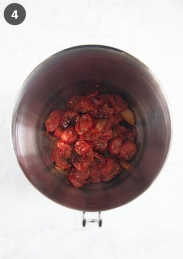 roasted tomatoes, onions and garlic in a large, metal bowl.