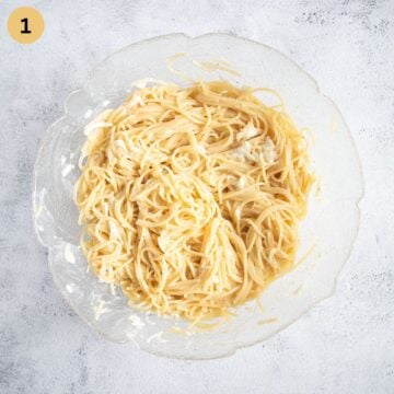 spaghetti mixed with sour cream and cheese in a bowl for making pizza crust.