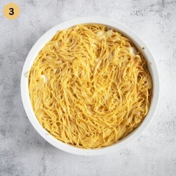 golden spaghetti pizza crust in a baking dish after baking.