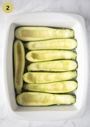 scooped-out zucchini flesh in a large baking dish before stuffing.