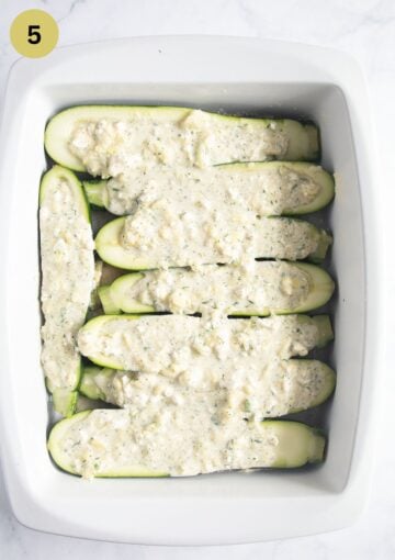 topping scooped-out zucchini halves with a mixture of feta, cream and chopped zucchini flesh.
