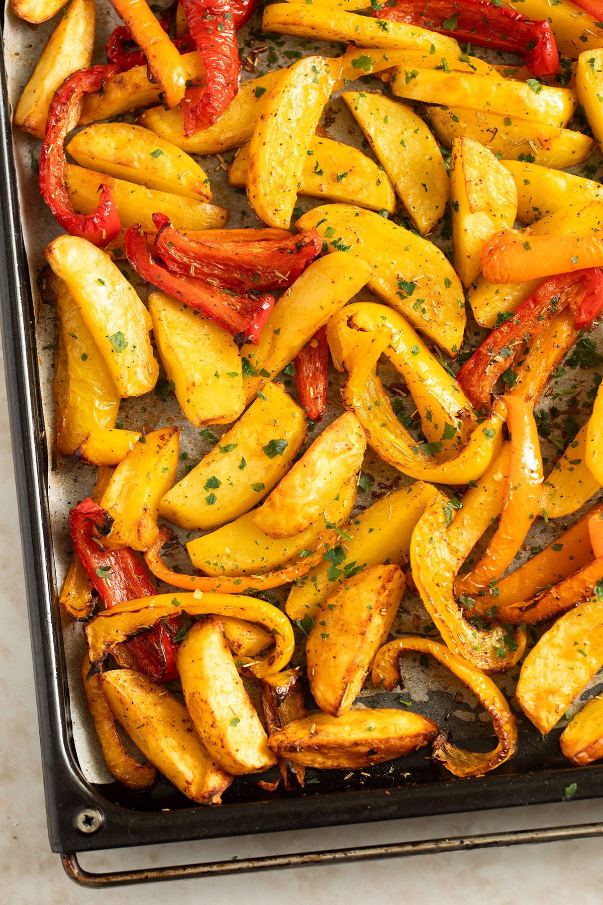 roasted peppers and potatoes on a large baking sheet.