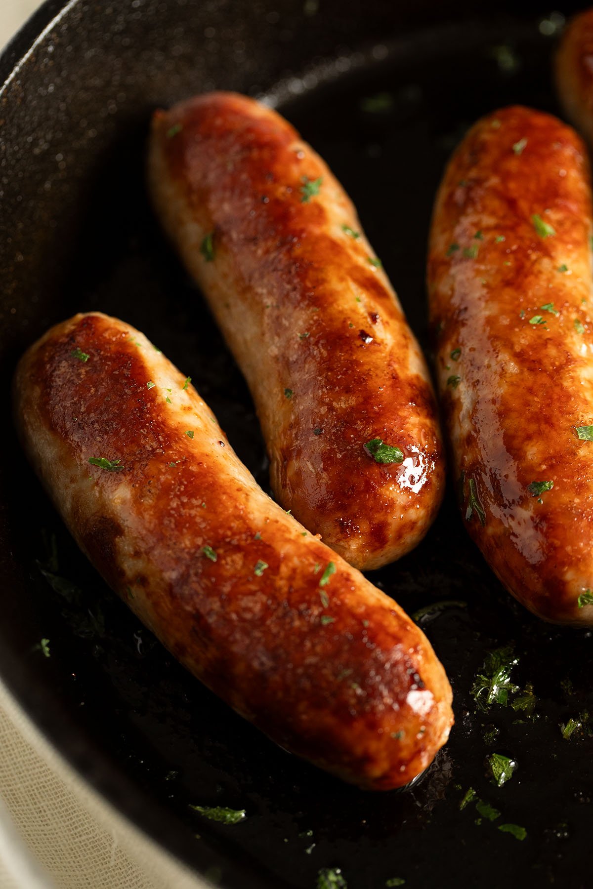 three golden and juicy baked italian sausages.