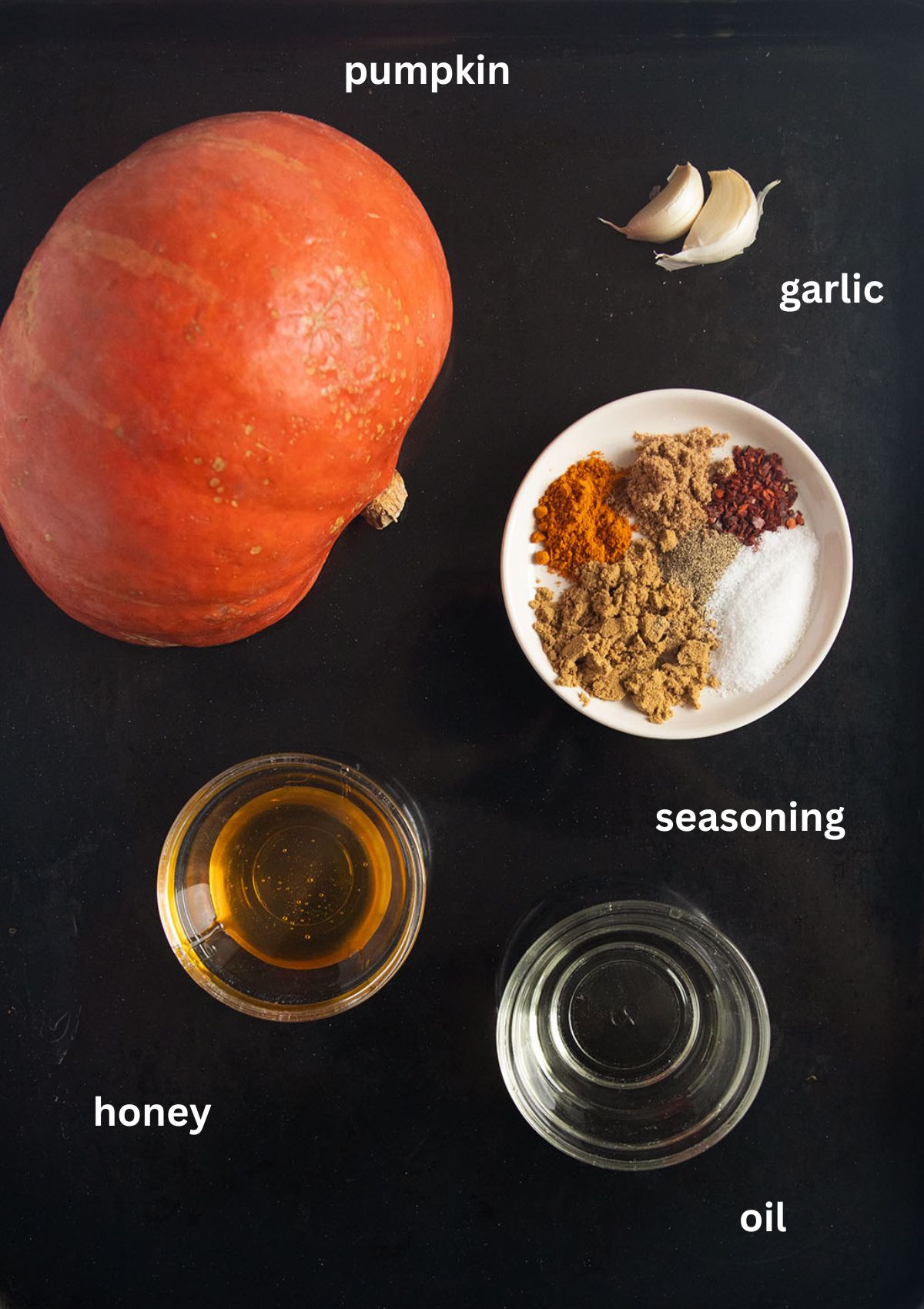 labeled ingredients for roasting pumpkin with hokkaido, many spices, honey and oil.