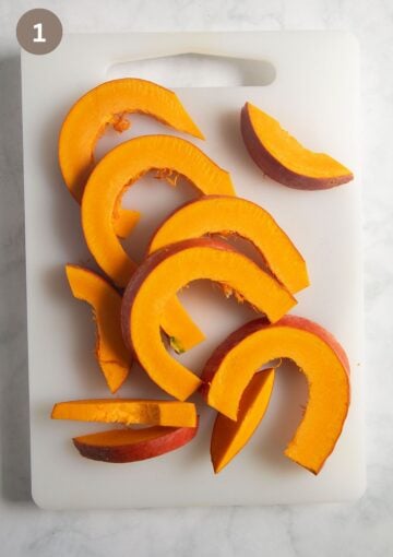 slices of raw pumpkin on a baking sheet.
