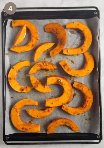 seasoned pumpkin slices on a lined baking sheet ready to be baked.