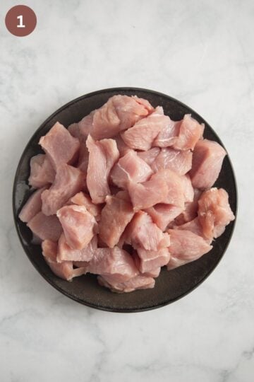 cubed turkey breast for making paprikash with turkey on a plate.