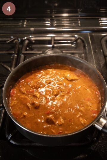 simmering turkey paprika with sauce in a large pot.