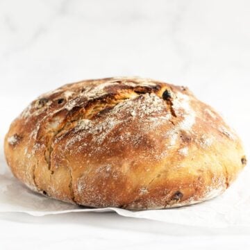 a round crusty loaf of walnut cranberry bread.