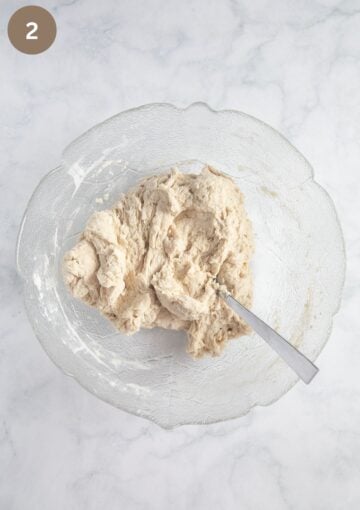 mixing flour, water and yeast to make the dough for walnut and cranberry bread.