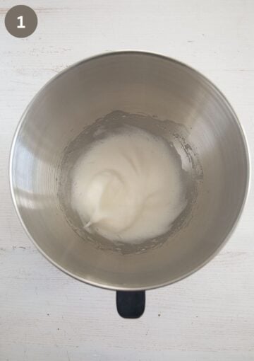 egg white beaten to form soft peaks in a large metal bowl.