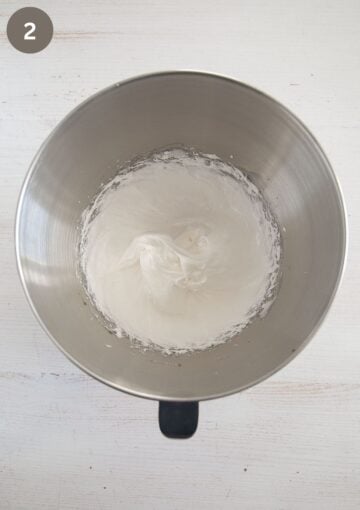 glossy and stiff beaten egg whites with sugar to make macaroons with almonds.