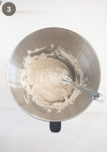 folding ground almonds into stiff egg whites with a spatula to make macaroons.