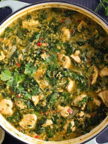 chicken lentil curry with spinach in a large dutch oven.