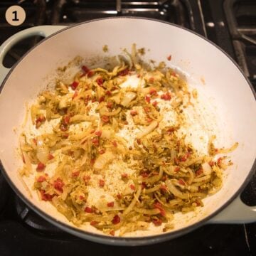 sauteing chopped onions, chili and curry powder in a pot to make curry.