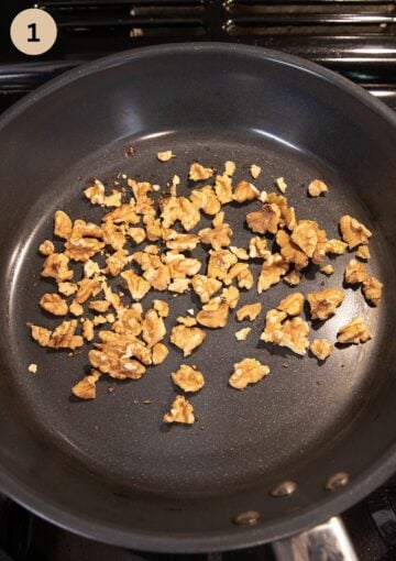 toasting chopped walnuts in a pan to add to a carrot and pineapple salad.