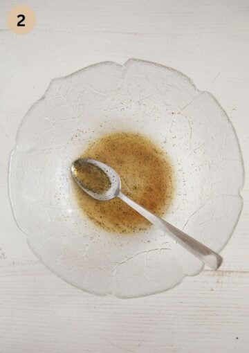 mixing maple syrup, lemon and pineapple juice, olive oil and seasoning in a bowl to make salad dressing.