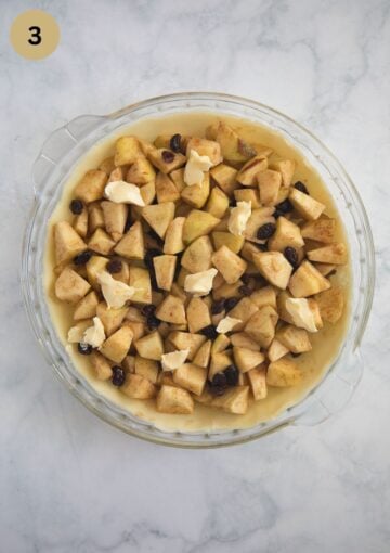 unbaked pie filled with apple filling in a pie dish.