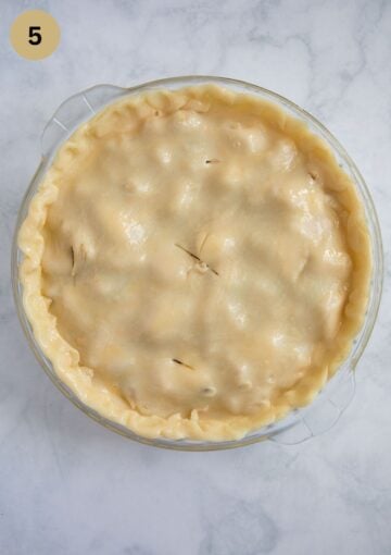 unbaked apple pie with double crust in a pie dish.