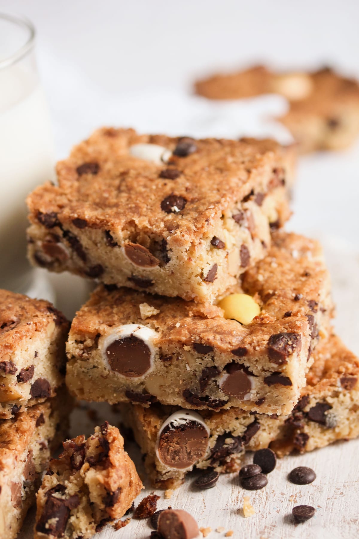 cadbury mini egg cookie bars stapled on the table, chocolate crumb around them.