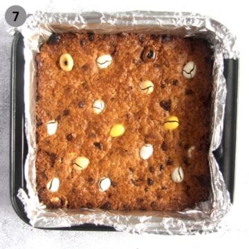 baked mini cookie bars with cadbury eggs in a foiled tin.