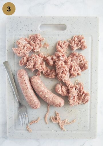 removing the casings from pork sausages and breaking the meat with a fork.