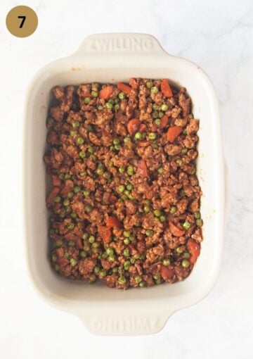 the pork and pea filling for shepherd's pie in a baking dish before baking.