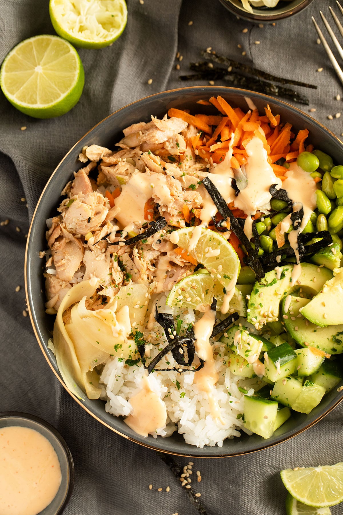 cooked salmon poke bowl with rice, avocado, vegetables and pickled ginger.