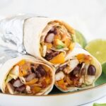 mexican chicken wraps stapled on a plate.