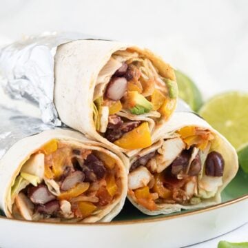 mexican chicken wraps stapled on a plate.