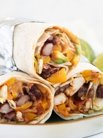 mexican chicken wraps stapled on a plate.