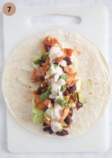 filling tortillas with chicken, avocado and spicy sauce.