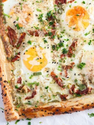 puff pastry egg tarts with pesto and sun-dried tomatoes.