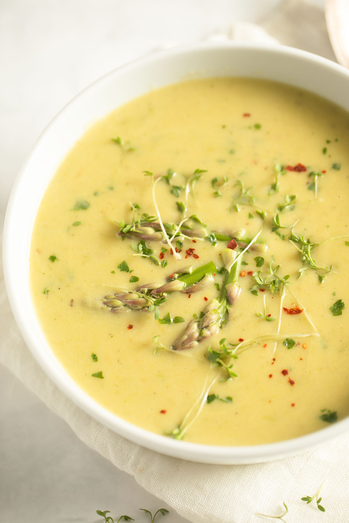 a bowl of hot and creamy potato and asparagus soup.