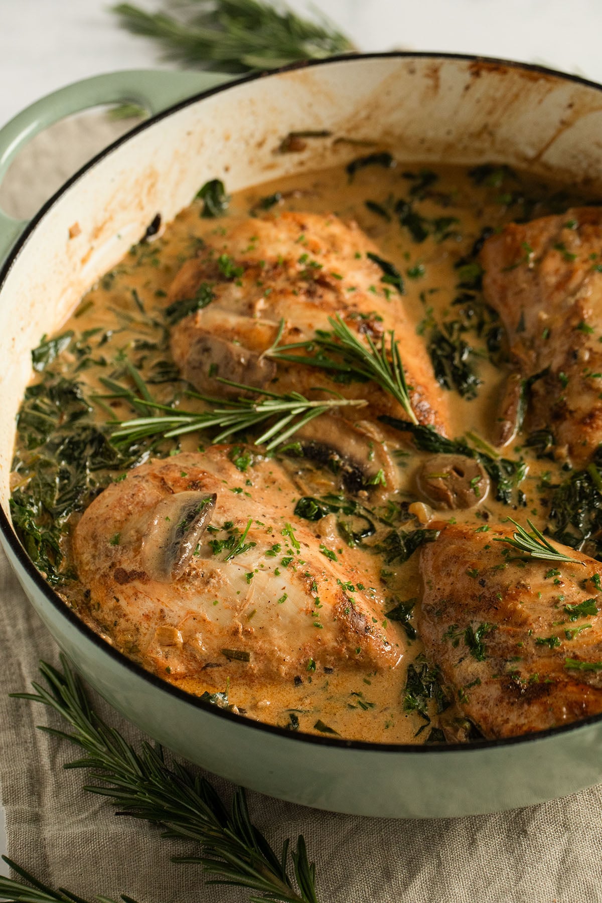 chicken breasts cooked in a creamy mushroom and spinach sauce.