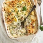 potato asparagus casserole showing the creamy filling with a spoon in it.